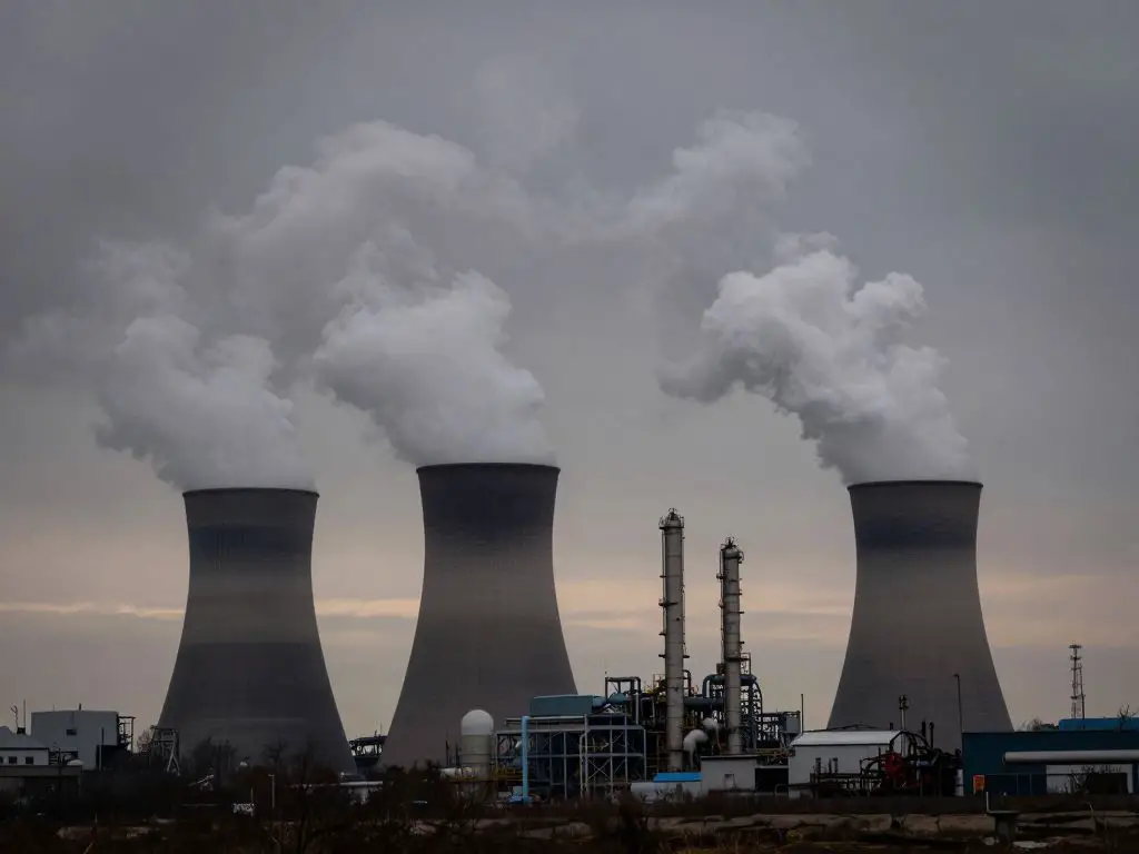 Fossil fuel power plants releasing pollution and greenhouse gas emissions