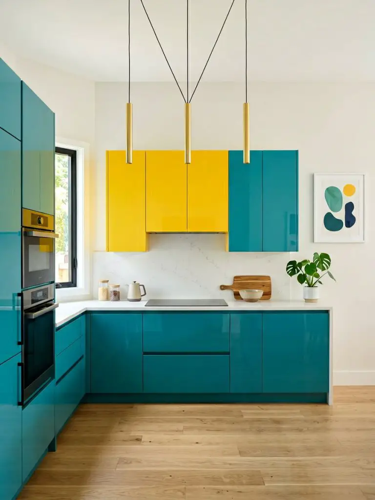 A bold, modern kitchen designed with playful color-block cabinetry in vibrant teal and sunny yellow, creating a striking geometric contrast.